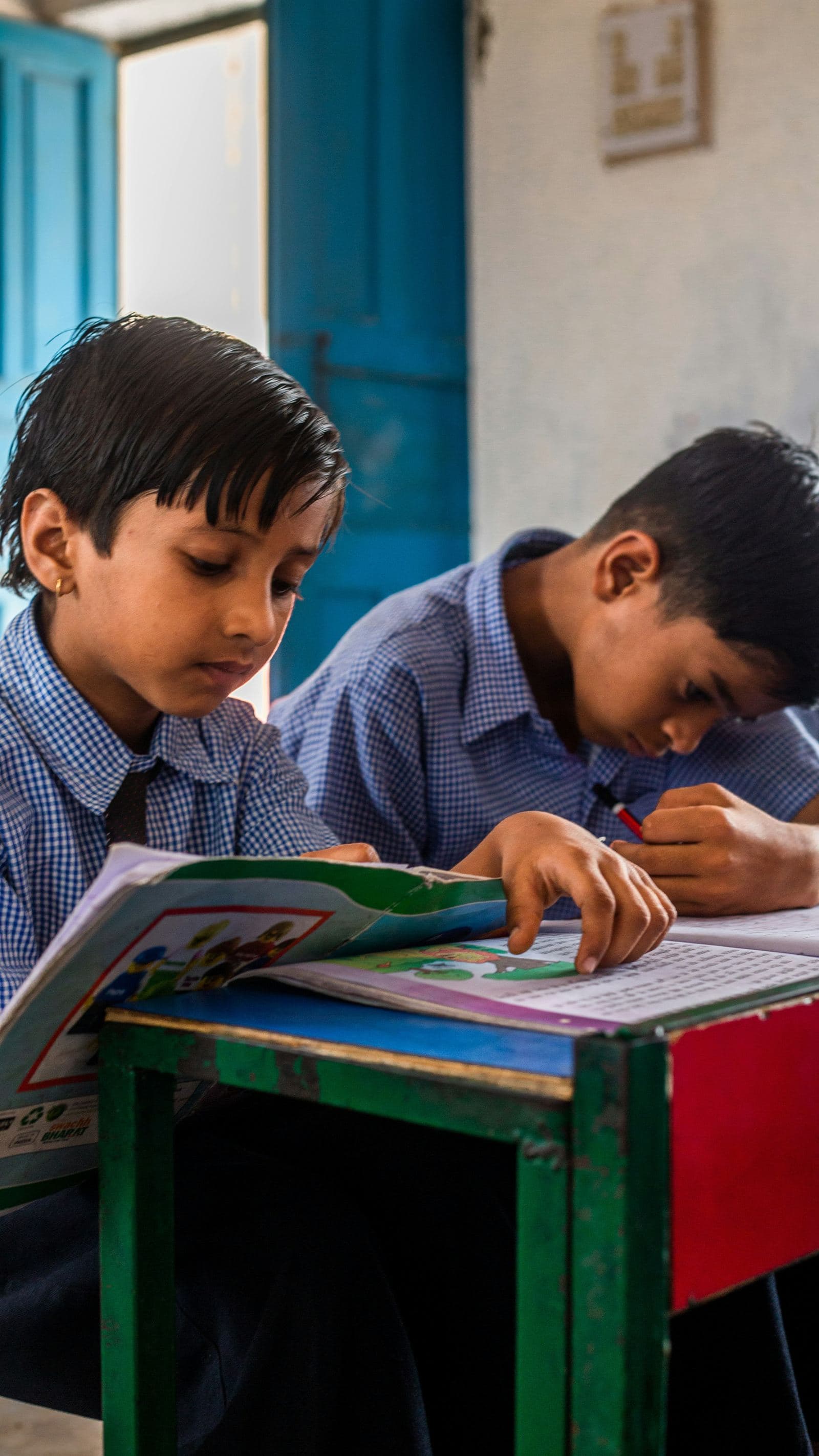A student reading a picture book in class