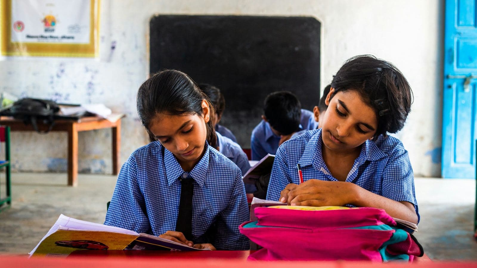 Two students working at their desks